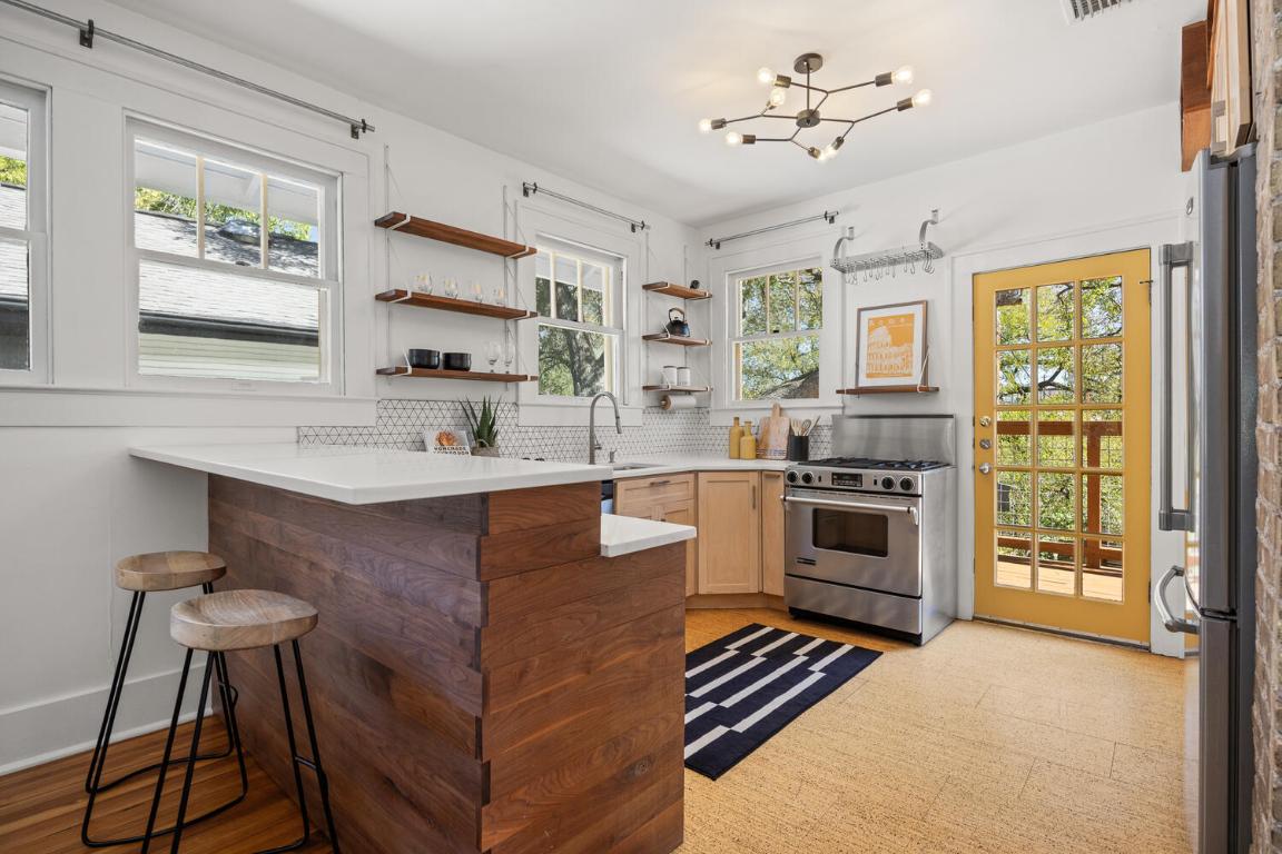 711 Patterson Avenue Austin, TX 78703 - Photo 11 of 21 a kitchen with a stove a sink and a refrigerator