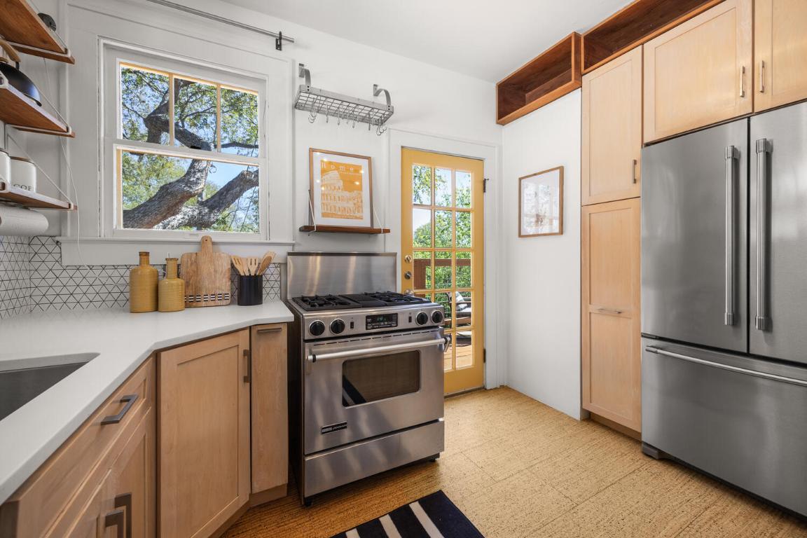 711 Patterson Avenue Austin, TX 78703 - Photo 13 of 21 a kitchen with a stove a refrigerator and a sink