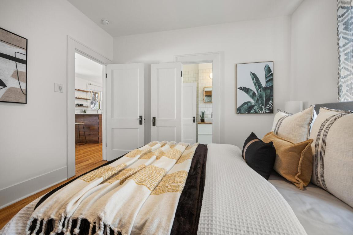 711 Patterson Avenue Austin, TX 78703 - Photo 5 of 21 a bedroom with a bed and a painting on the wall