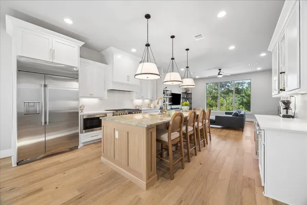 a living room with furniture a flat screen tv and a window