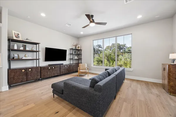 a view of a hallway with wooden floor and windows