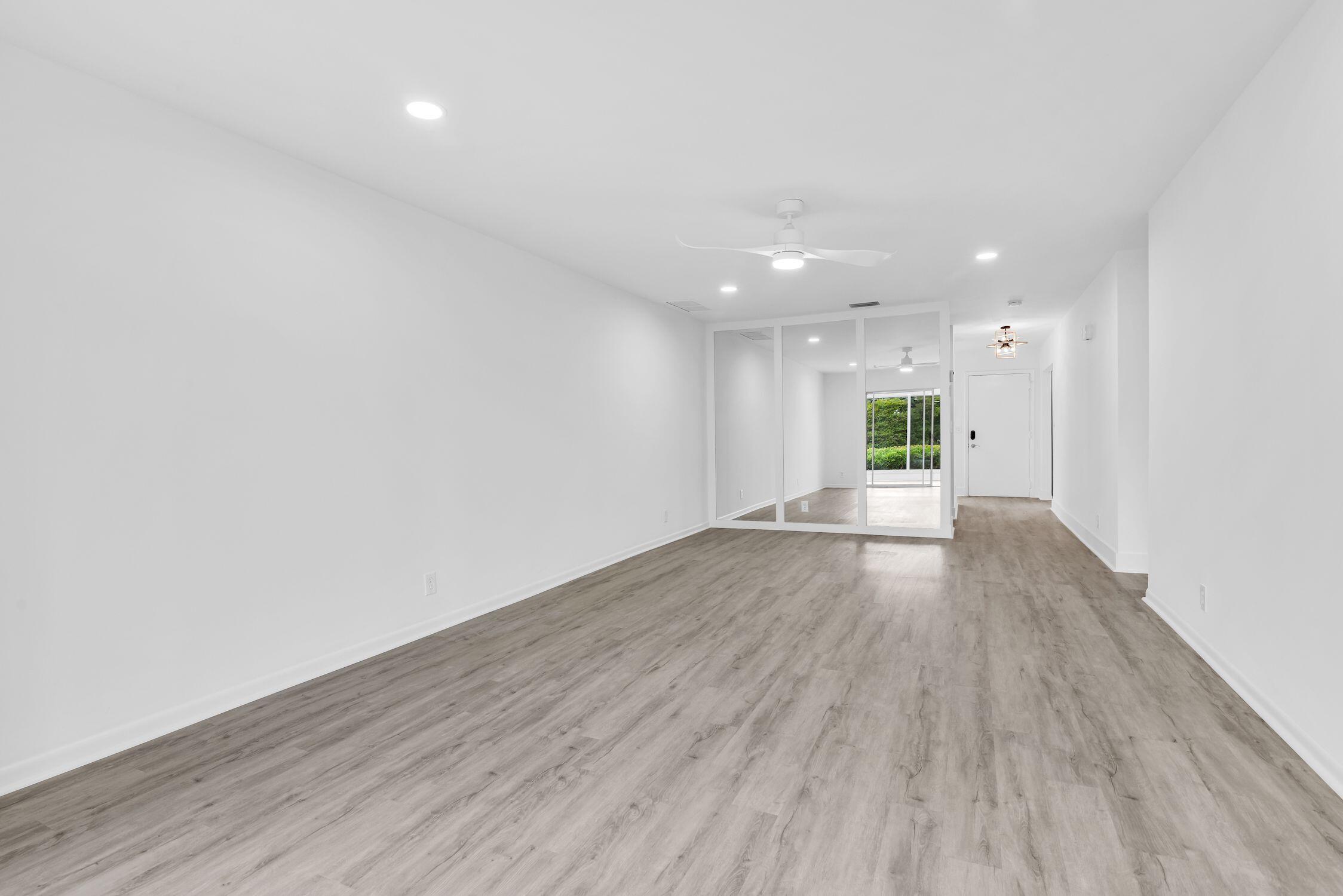 8807 Bella Vista Drive, Unit 280 Boca Raton, FL 33433 - Photo 11 of 44 a view of an empty room with wooden floor