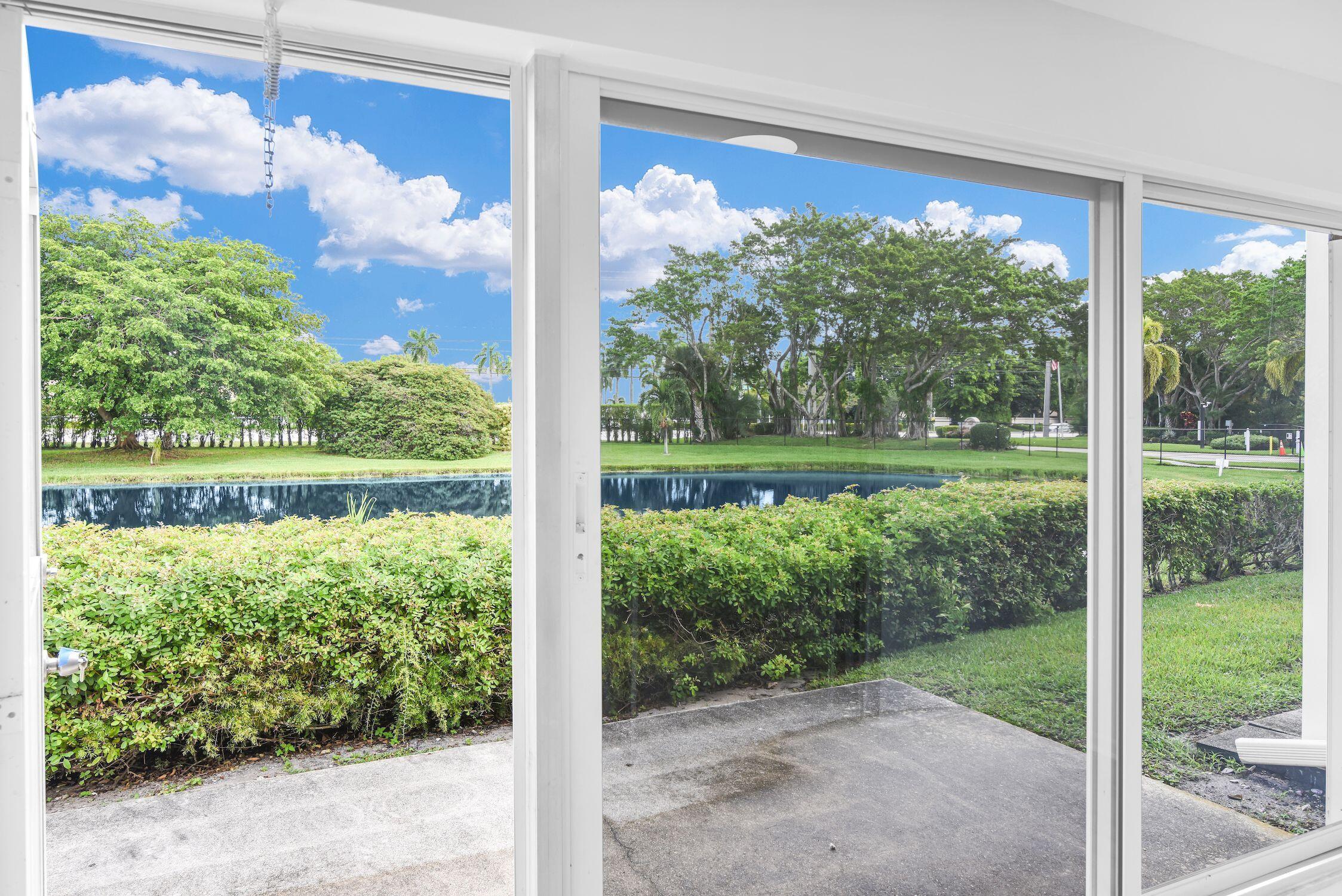 8807 Bella Vista Drive, Unit 280 Boca Raton, FL 33433 - Photo 17 of 44 a view of a garden from a window