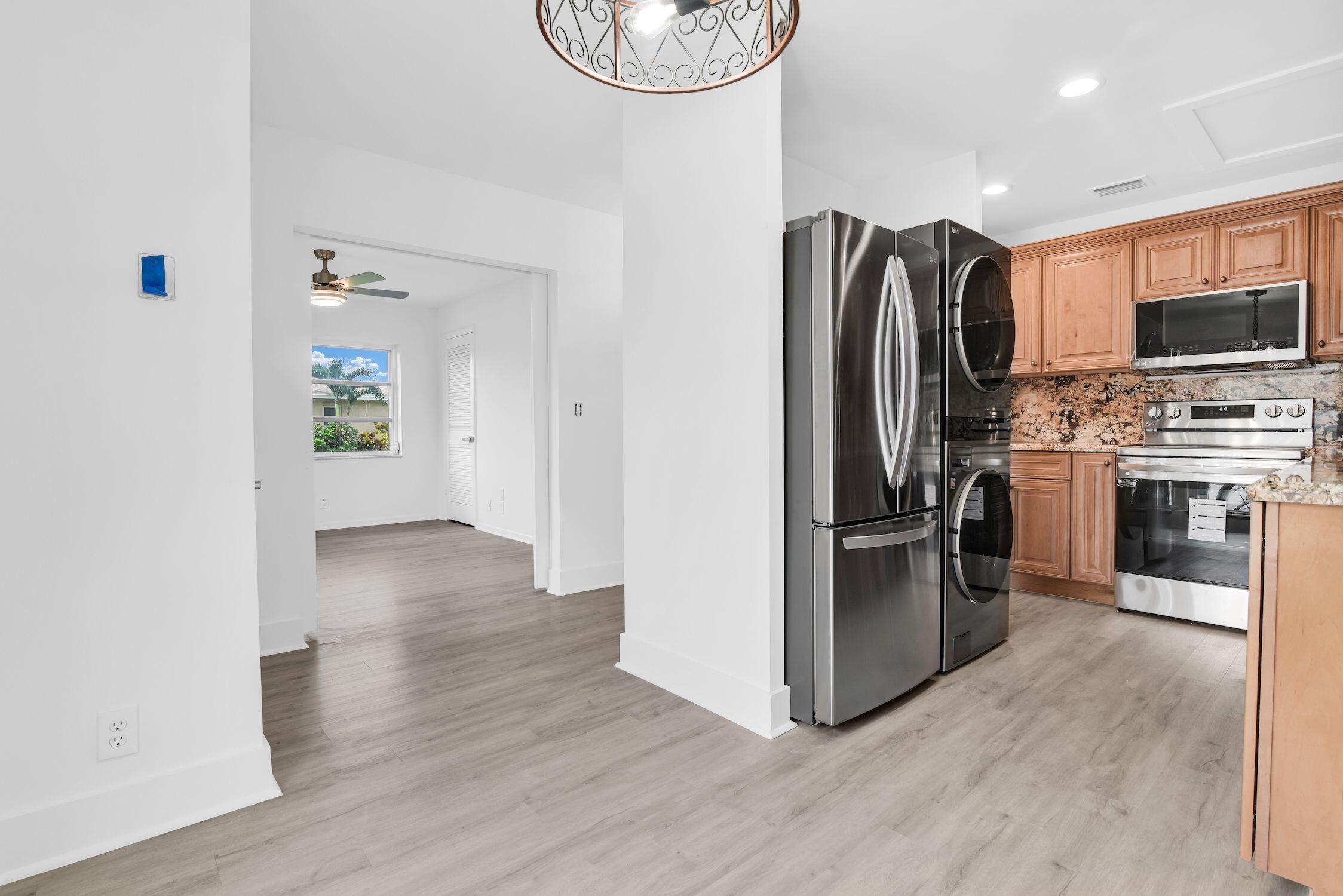 8807 Bella Vista Drive, Unit 280 Boca Raton, FL 33433 - Photo 3 of 44 a kitchen with stainless steel appliances a refrigerator stove and microwave