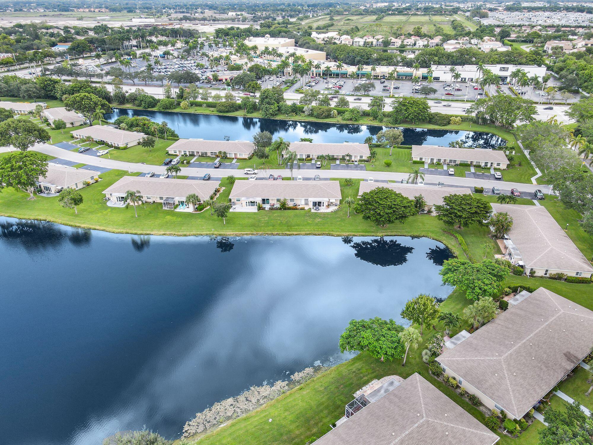 8807 Bella Vista Drive, Unit 280 Boca Raton, FL 33433 - Photo 39 of 44 an aerial view of a city with lots of residential buildings ocean and mountain view in back