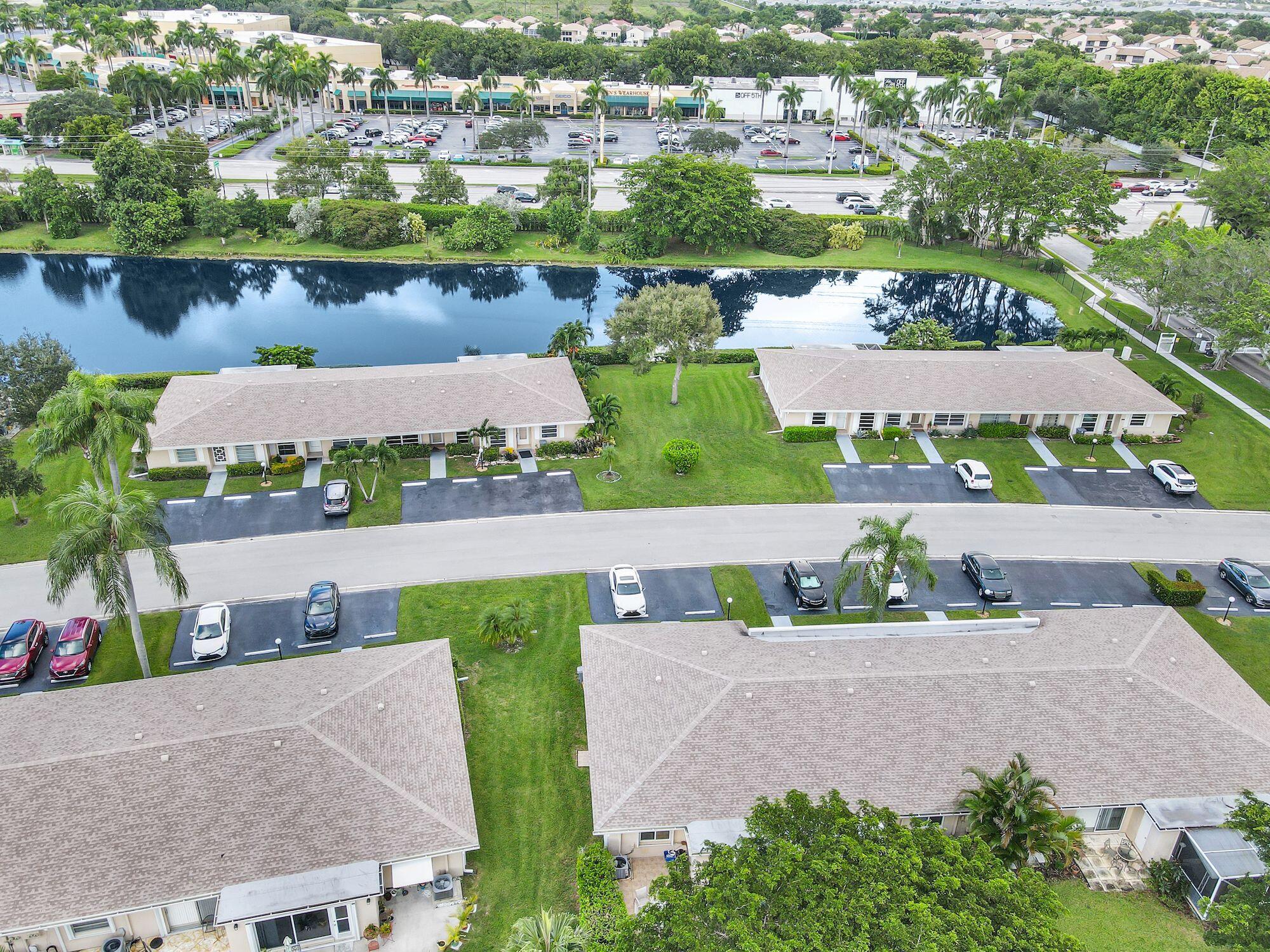 8807 Bella Vista Drive, Unit 280 Boca Raton, FL 33433 - Photo 40 of 44 an aerial view of a house with a garden and lake view