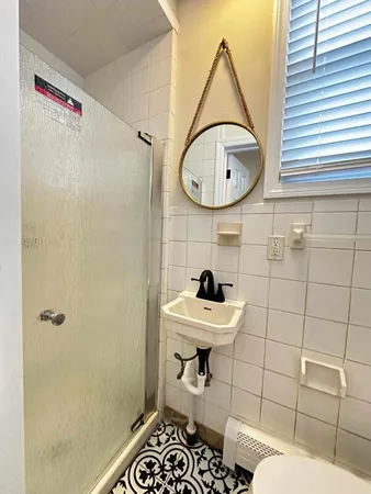 a bathroom with a sink a mirror and a toilet