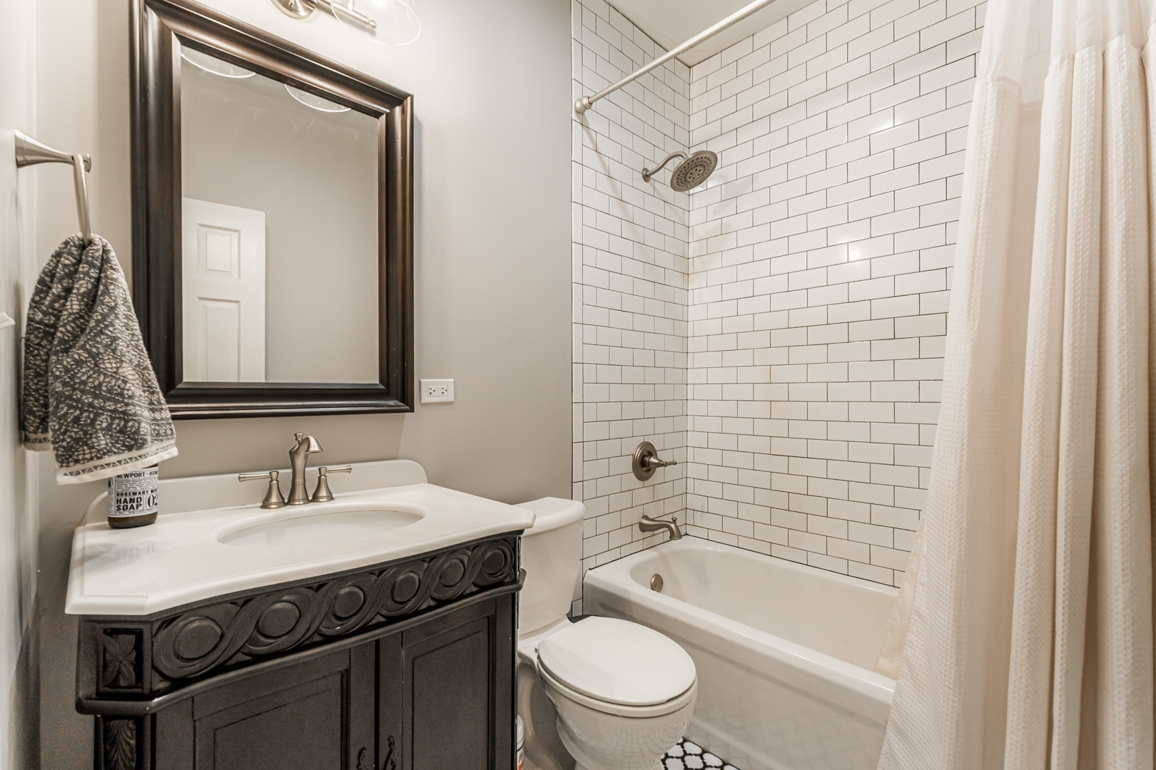 18715 West Edwards Road Antioch, IL 60002 - Photo 18 of 66 a bathroom with a granite countertop toilet a sink a mirror a bathtub and shower