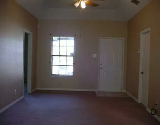 an empty room with windows and closet