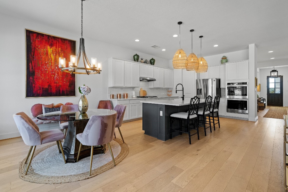 Featuring tall ceilings, white oak hardwood floors, LED recessed lighting, and tastefully selected, updated modern light fixtures and ceiling fans.