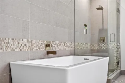 a bathroom with a bathtub and shower