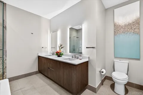 a bathroom with a sink toilet and mirror