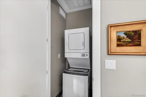 a room with painting and a refrigerator