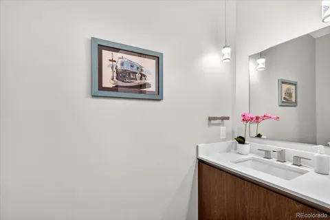 a bathroom with a granite countertop sink a mirror and a shower
