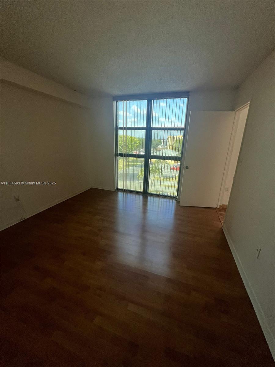 International Park Miami, FL 33175 - Photo 11 of 26 a view of an empty room with wooden floor and a window