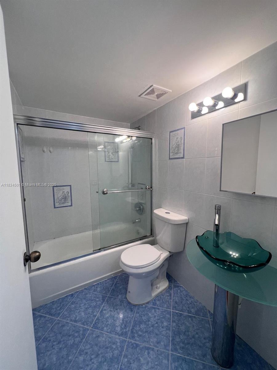 International Park Miami, FL 33175 - Photo 12 of 26 a bathroom with a toilet and a shower