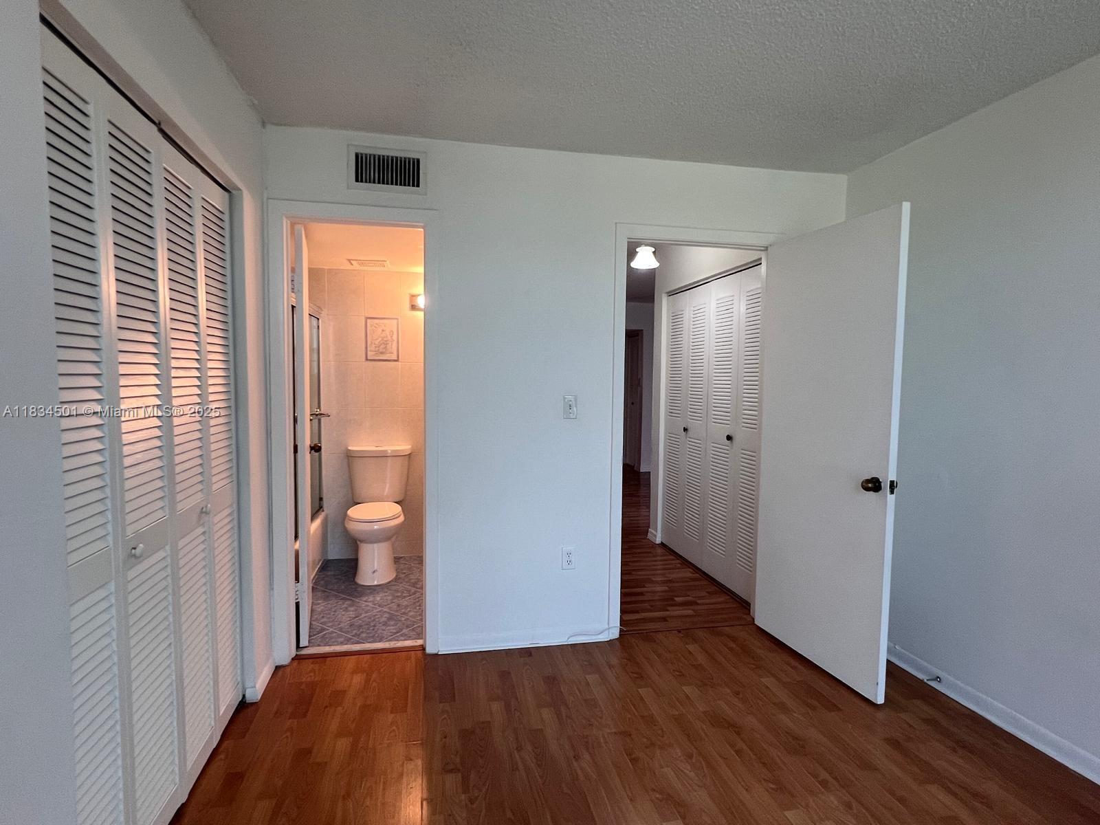 International Park Miami, FL 33175 - Photo 14 of 26 a view of a room with wooden floor and a bathroom