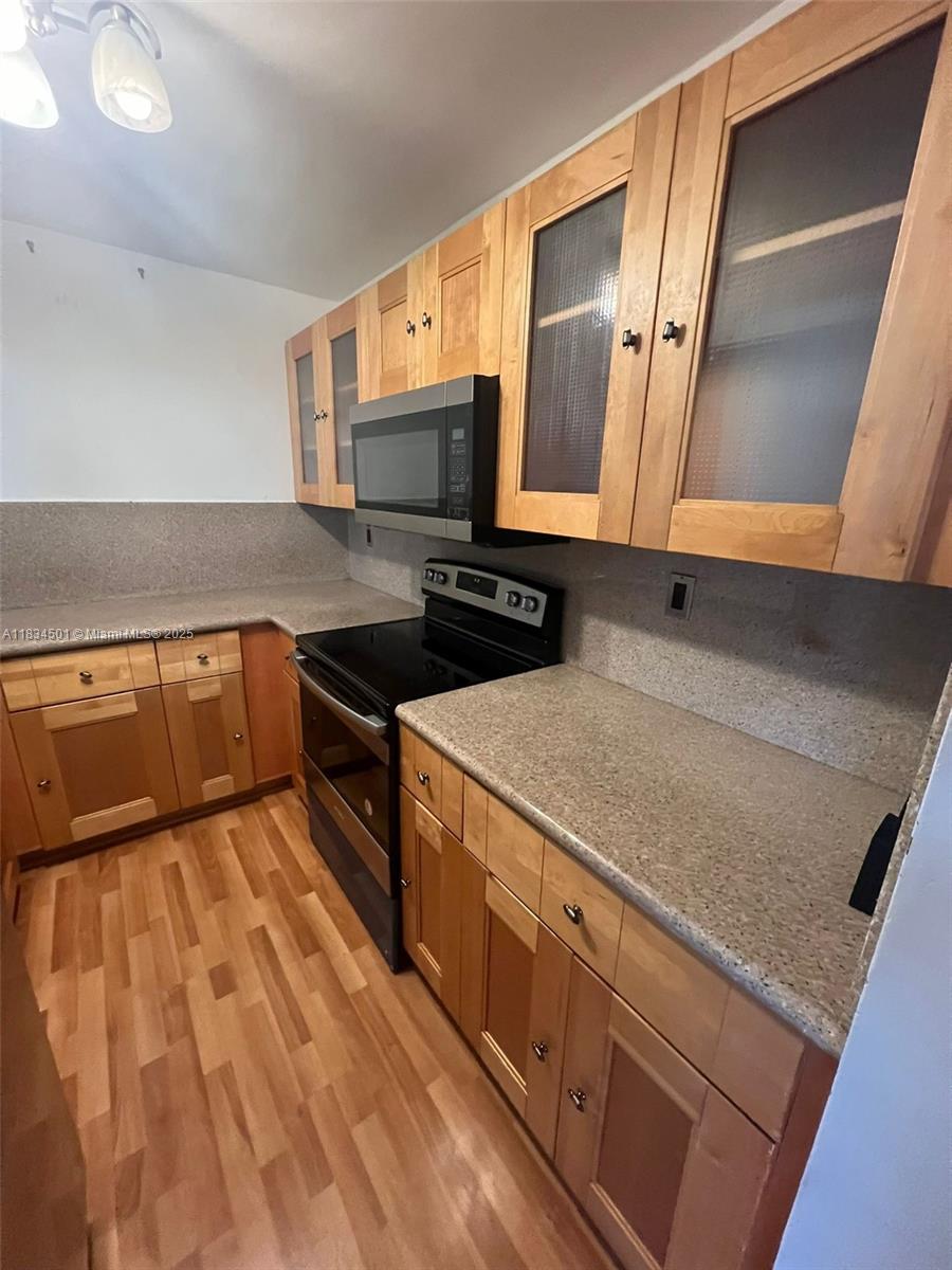 International Park Miami, FL 33175 - Photo 2 of 26 a kitchen with stainless steel appliances granite countertop a sink stove and cabinets
