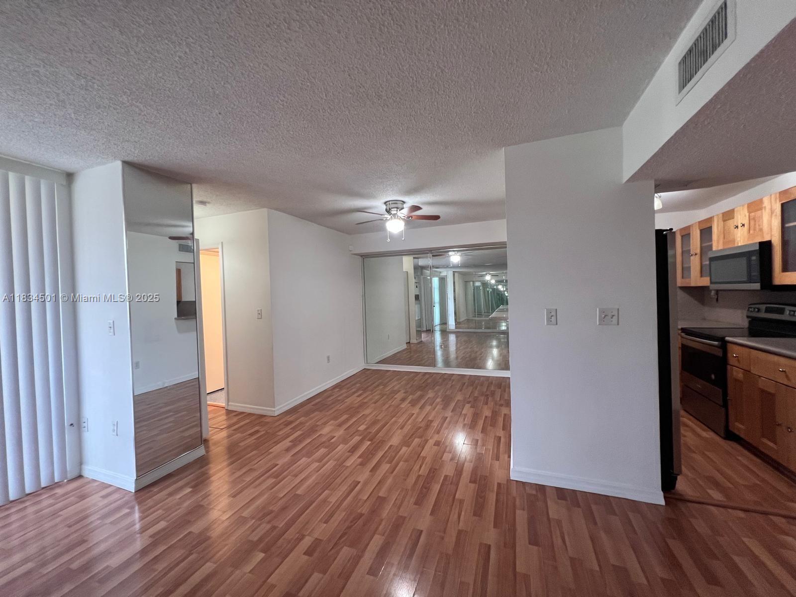 International Park Miami, FL 33175 - Photo 4 of 26 a view of hallway with wooden floor and cabinets