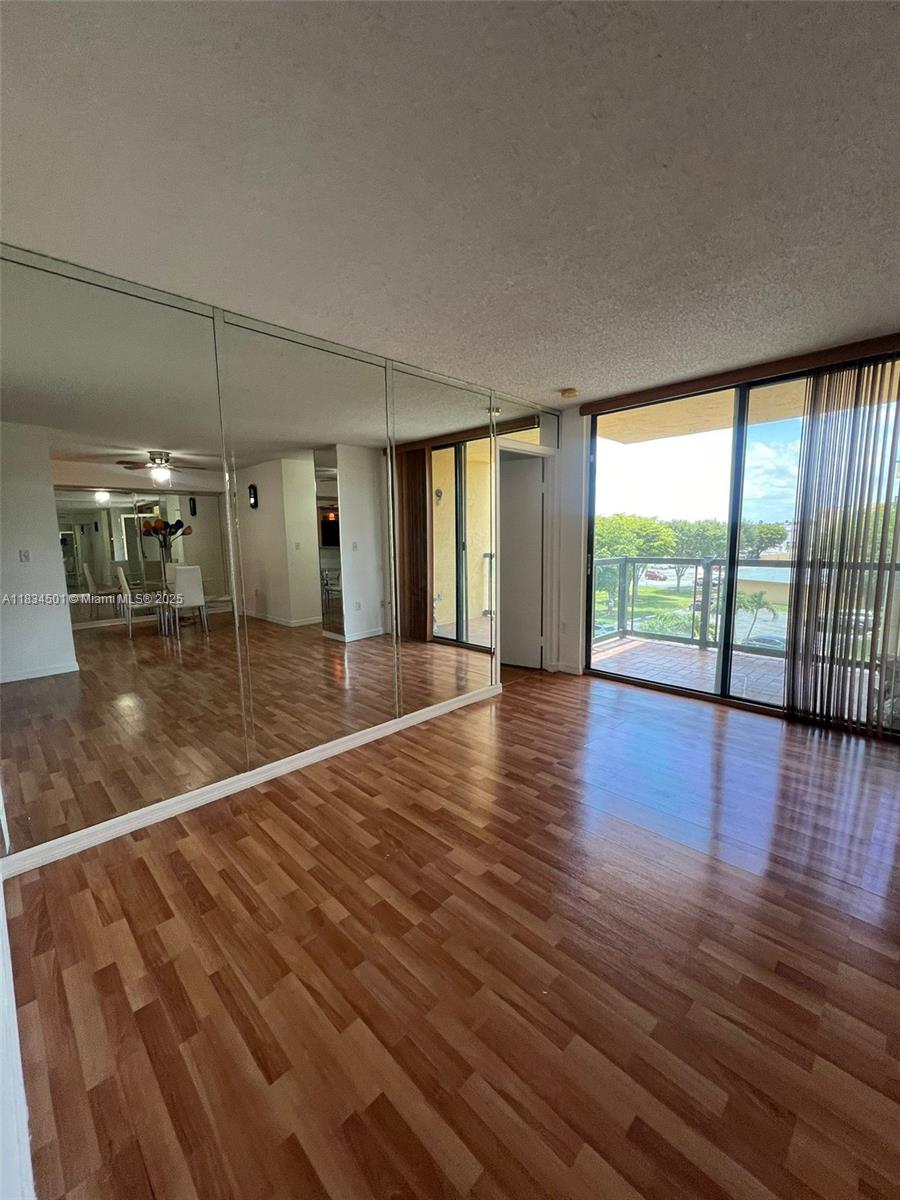 International Park Miami, FL 33175 - Photo 6 of 26 an empty room with wooden floor and windows