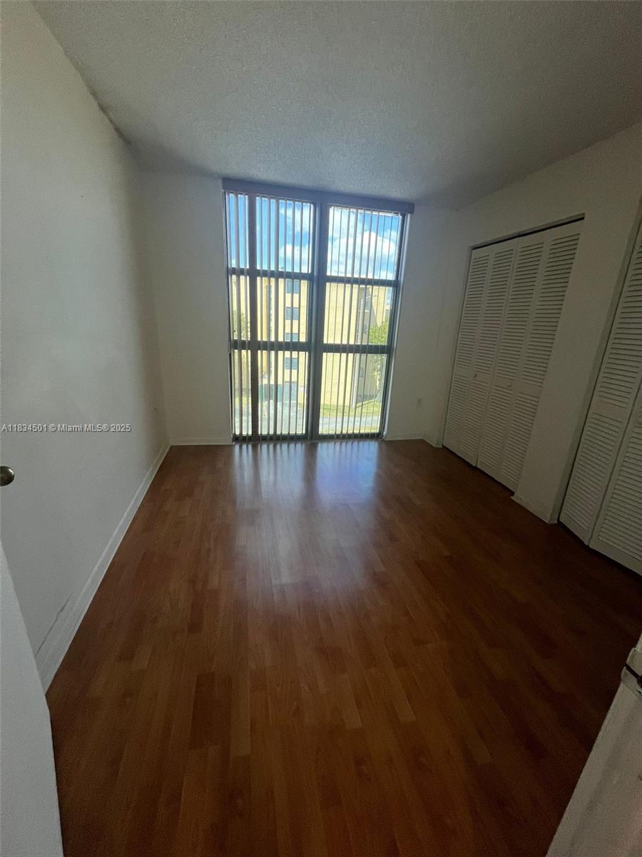International Park Miami, FL 33175 - Photo 8 of 26 wooden floor in an empty room with a window