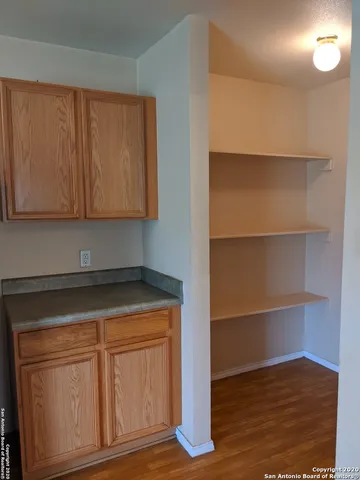 a view of a room with wooden floor