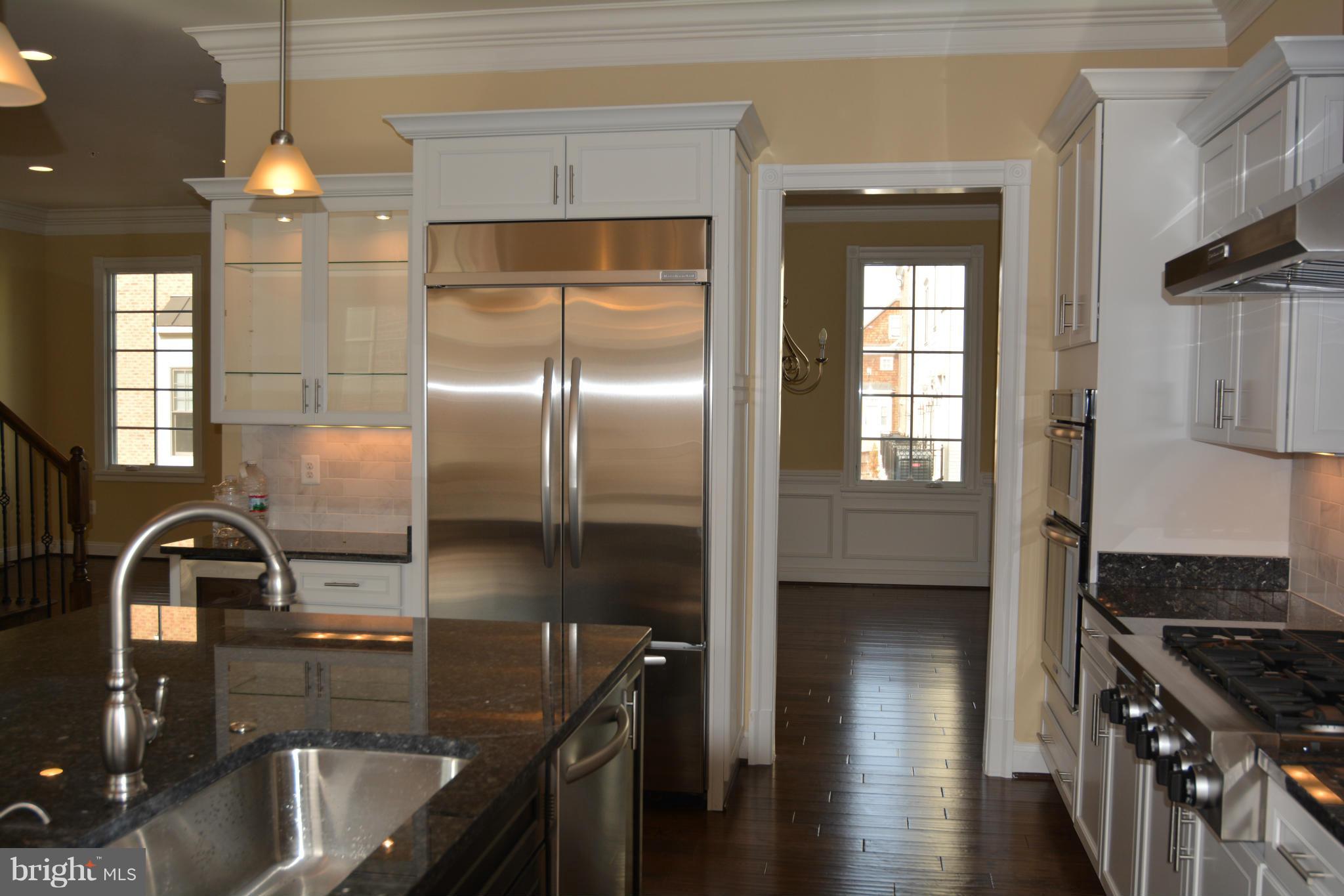 1411 Ridgeview Way Washington, DC 20007 - Photo 3 of 15 a kitchen with granite countertop a stove a sink and a refrigerator