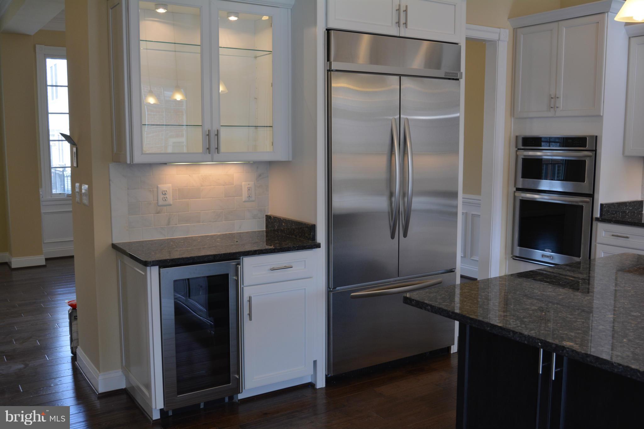 1411 Ridgeview Way Washington, DC 20007 - Photo 4 of 15 a kitchen with kitchen island a counter top space cabinets and stainless steel appliances