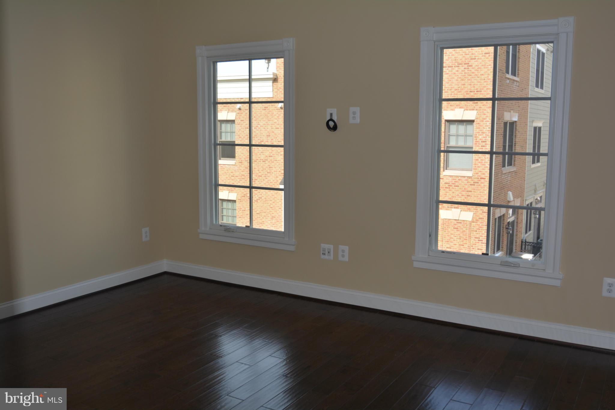 1411 Ridgeview Way Washington, DC 20007 - Photo 6 of 15 an empty room with wooden floor and windows