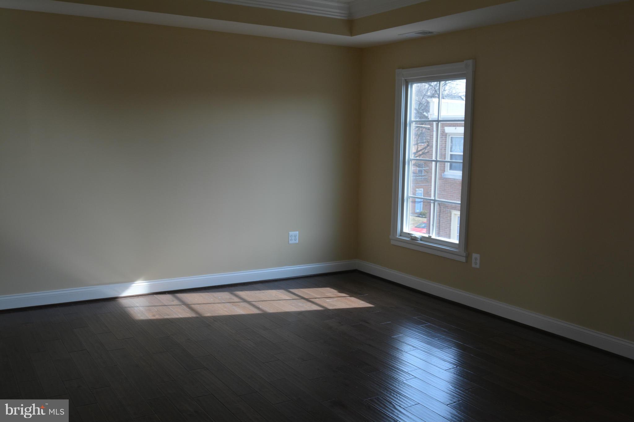 1411 Ridgeview Way Washington, DC 20007 - Photo 10 of 15 an empty room with wooden floor and windows