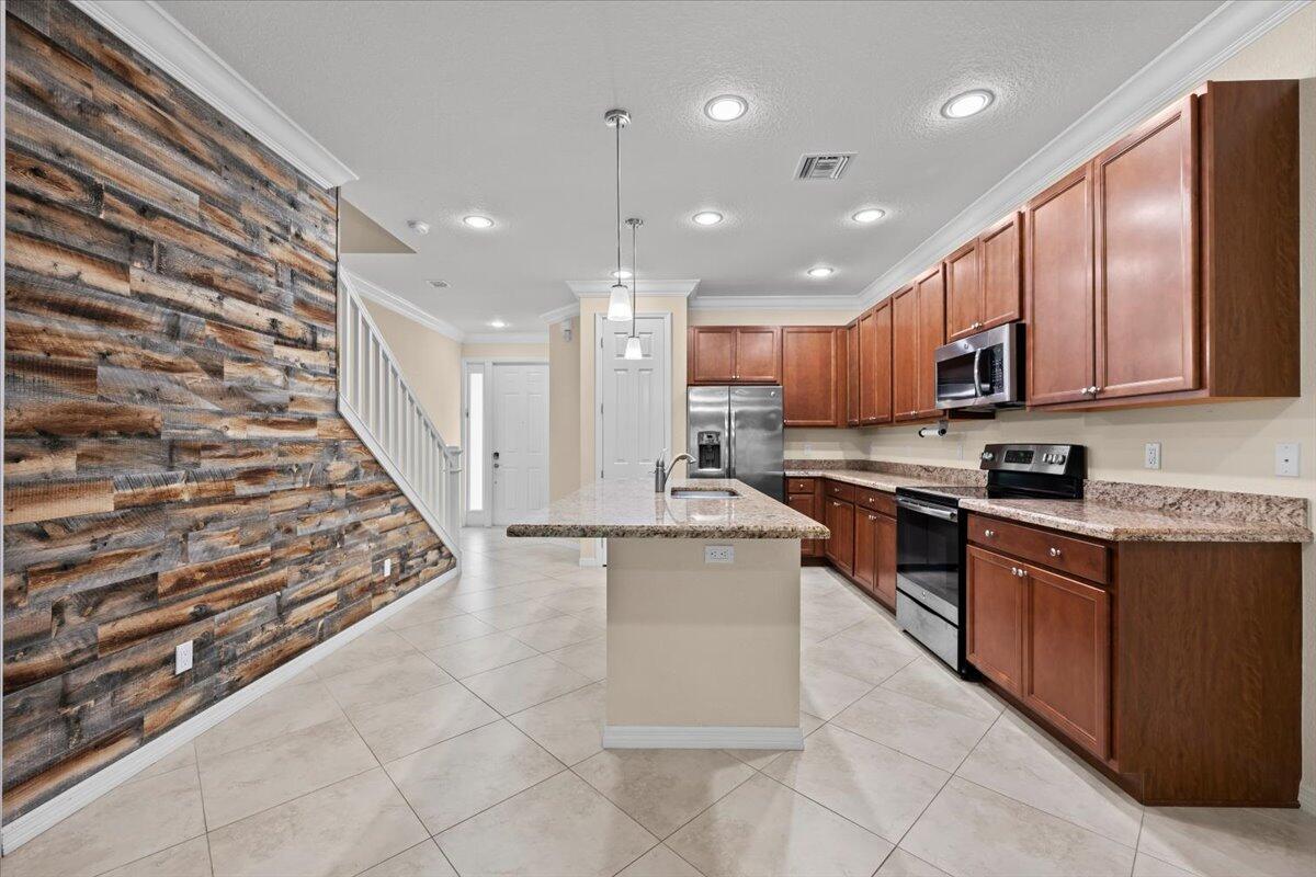 a large kitchen with stainless steel appliances lots of counter space