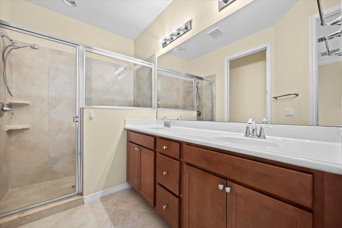 535 Southwest Glen Crest Way Stuart, FL 34997 - Photo 16 of 32 a bathroom with a granite countertop sink mirror and double