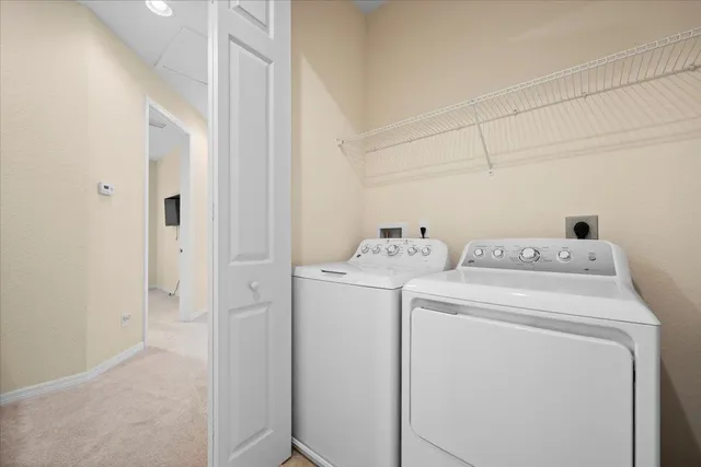 a view of storage and utility room with washer and dryer