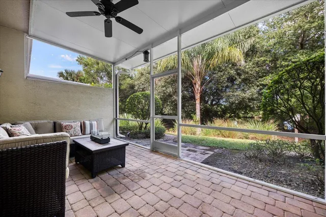 a living room with patio furniture and a garden
