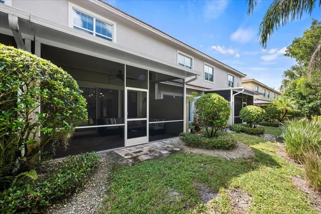 a backyard of a house with plants and outdoor seating