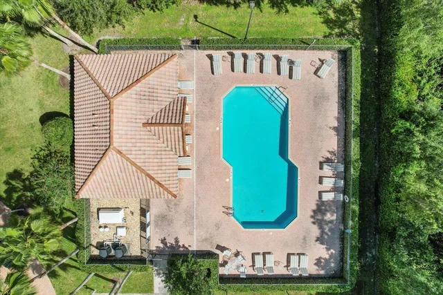 a view of a house with a yard and potted plants