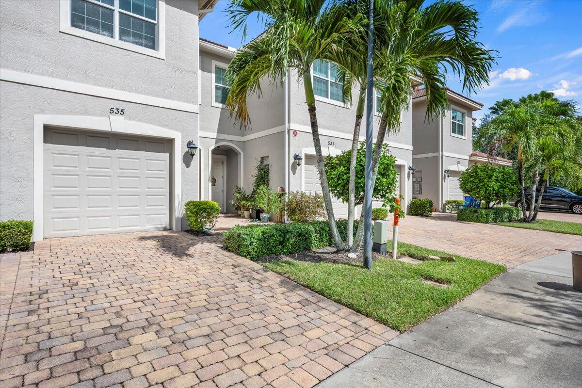 535 Southwest Glen Crest Way Stuart, FL 34997 - Photo 28 of 32 a front view of a house with garden