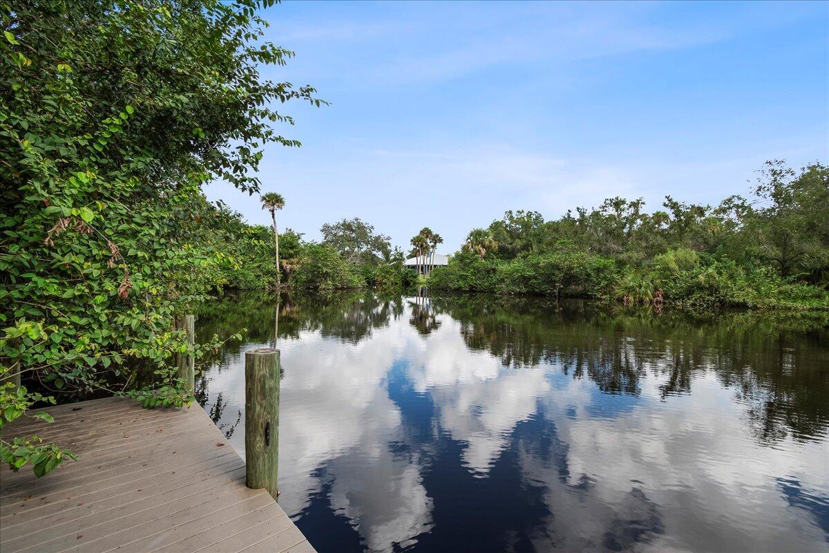 535 Southwest Glen Crest Way Stuart, FL 34997 - Photo 3 of 32 a view of a lake in a forest