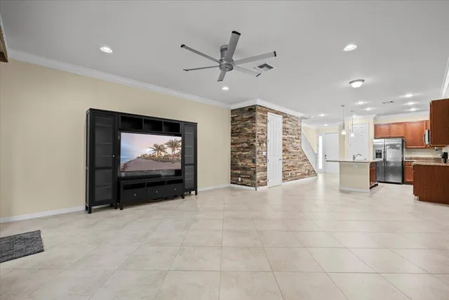 a view of a livingroom with furniture and a ceiling fan
