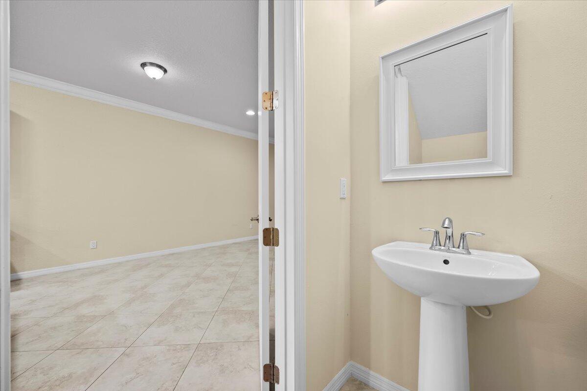 535 Southwest Glen Crest Way Stuart, FL 34997 - Photo 10 of 32 a bathroom with a sink and a mirror