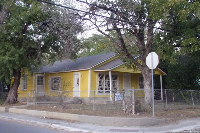 a front view of a house with garden and plants