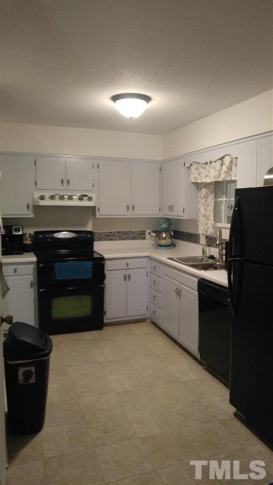 5114 Flint Ridge Place, Unit 5114 Raleigh, NC 27609 - Photo 3 of 9 a kitchen with a sink a stove and refrigerator