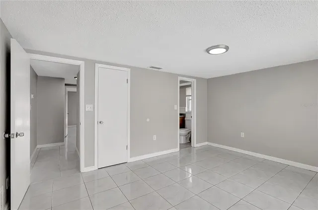 a view of an empty room and closet area