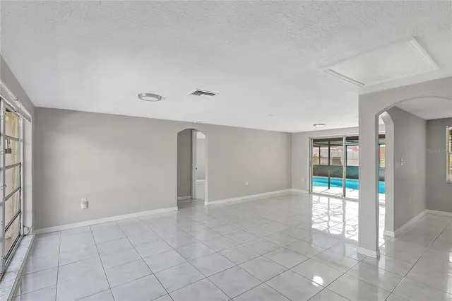 an empty room with entrance and windows