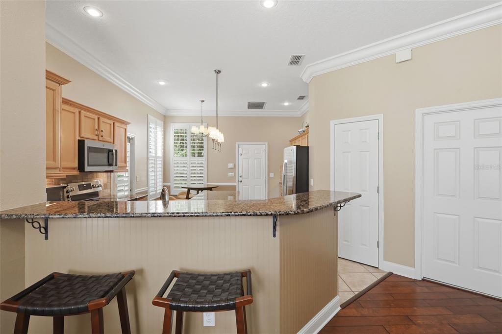 907 Pawstand Road Celebration, FL 34747 - Photo 16 of 49 a kitchen with stainless steel appliances granite countertop a sink and a refrigerator