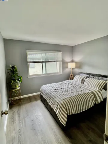 a bedroom with a bed and windows