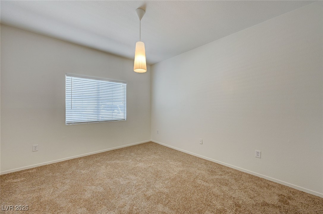 6160 Rumrill Street, Unit 232 Las Vegas, NV 89113 - Photo 18 of 26 Unfurnished room featuring baseboards and carpet flooring