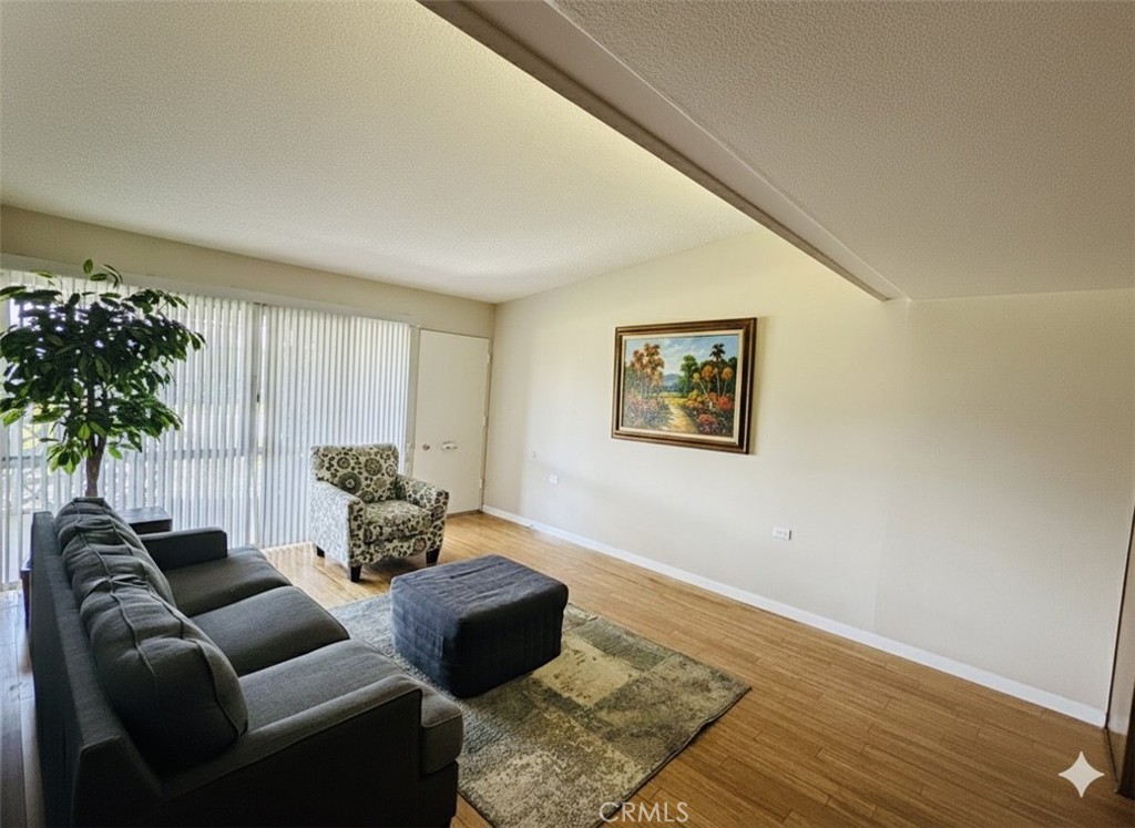 1661 Monterey Road, Unit 16D Seal Beach, CA 90740 - Photo 4 of 9 a living room with furniture and a potted plant