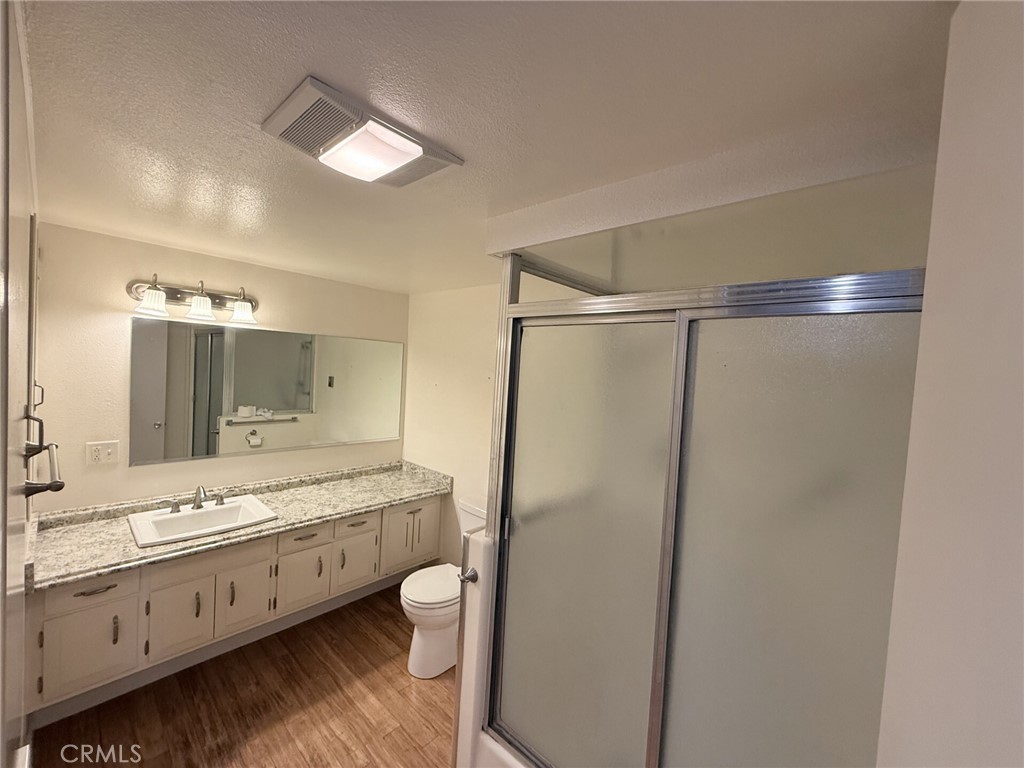 1661 Monterey Road, Unit 16D Seal Beach, CA 90740 - Photo 7 of 9 a bathroom with a double vanity sink toilet and shower