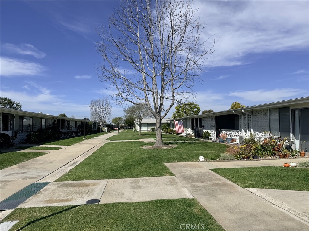 1661 Monterey Road, Unit 16D Seal Beach, CA 90740 - Photo 8 of 9 a front view of a house with garden